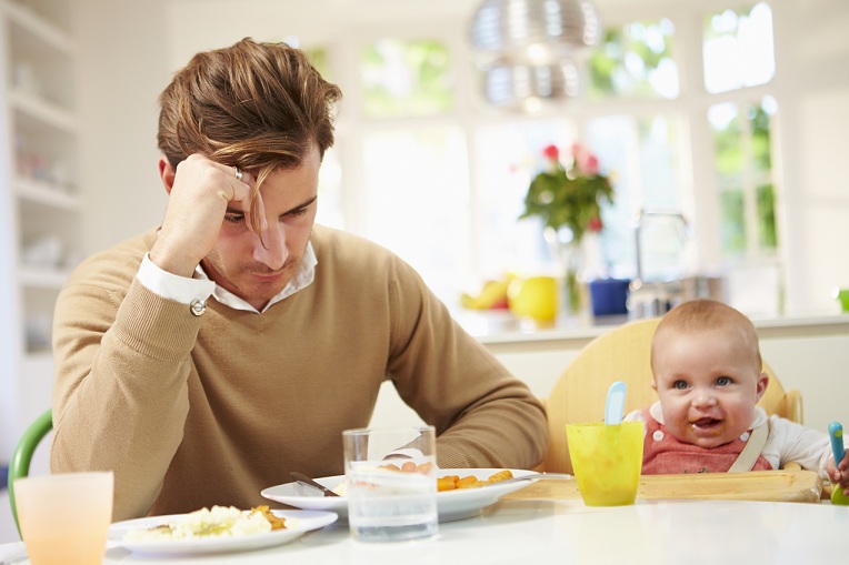 Father Feeling Depressed At Baby's Mealtime