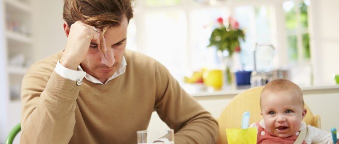 Father Feeling Depressed At Baby's Mealtime