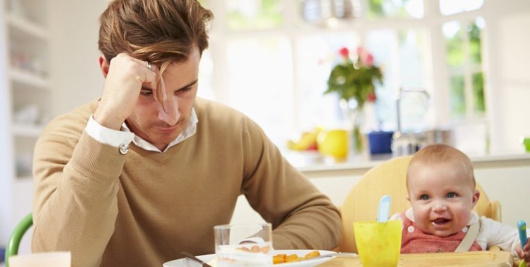 Father Feeling Depressed At Baby's Mealtime